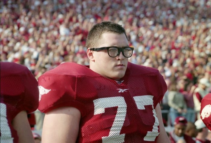 Brandon Burlsworth is on the sideline of a Razorback game wearing his iconic glasses.
